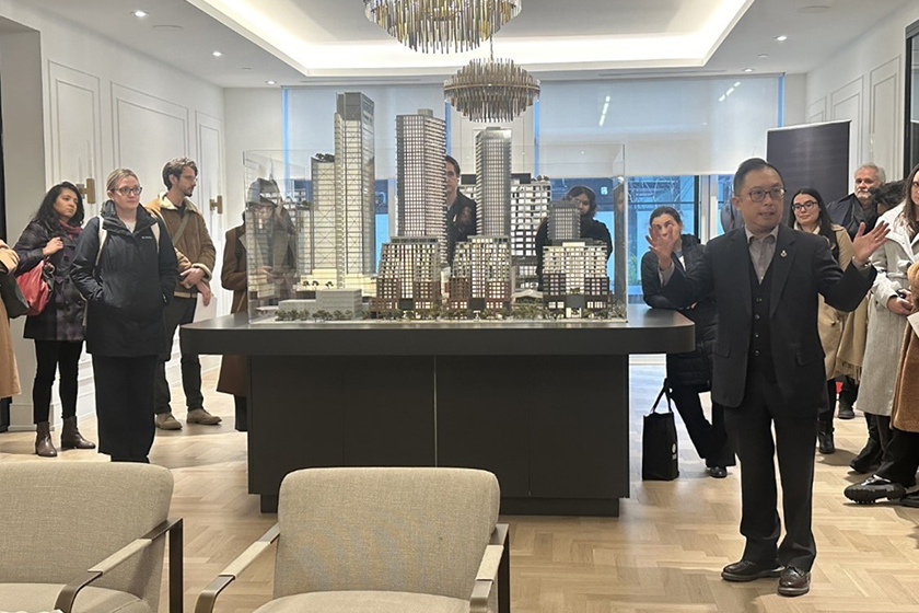 This photo, taken by Nicole Lechter, shows a model of a master-planned community as one of the executives speaks to a room of people about the project. 
